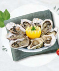 Plate of fresh Les Huîtres oysters served with lemon and garnished with parsley on a napkin.