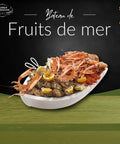 Bateau fruits de mer gourmet platter with oysters, langoustines, gambas, bulots, and crab claws on ice