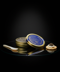Caviar Golestan Iran in gold tin with serving spoon and cracker on black reflective surface