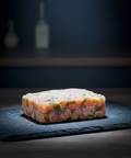 Frozen salmon tartare with dill on black slate plate